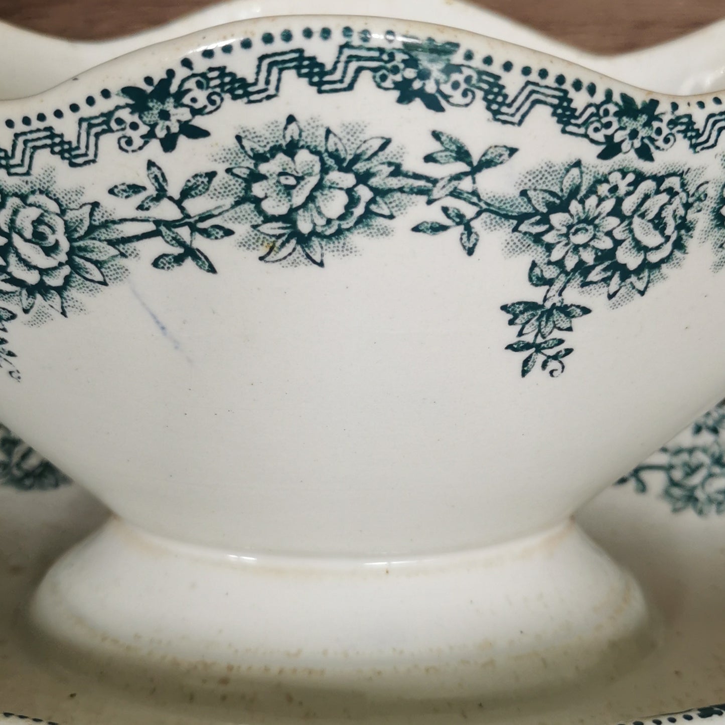 old sauce boat with green decor