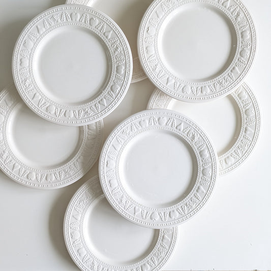 8 White glazed ceramic dessert plates with reliefs